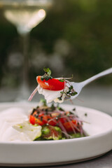 Eating healthy fresh delicious salad for lunch outdoors