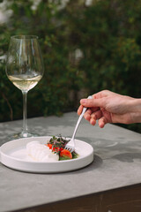 Enjoying a fresh mozzarella and tomato salad with white wine