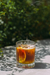 Refreshing iced coffee drink with orange and ice