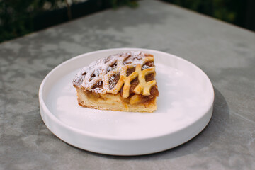Slice of apple pie dessert with powdered sugar