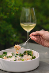 Enjoying pasta with seafood and white wine al fresco