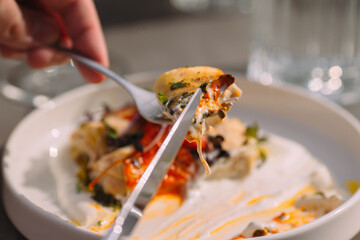 Person cutting gourmet food, a delicious meal