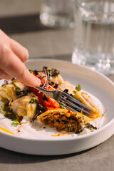 Sampling delicious gourmet food dish with fork