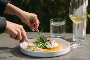 Person enjoying a meal with eggs and vegetables