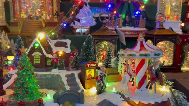 London, UK, November 24, 2024. Christmas display at Harrods store. Music boxes shaped like carousels, gingerbread houses, and Christmas trees &ndash; all spinning, with lights glowing. Festive Christmas atm