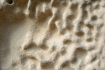 Sculpted stone surface with unique texture. This image represents natural erosion and geological process creating abstract forms over time