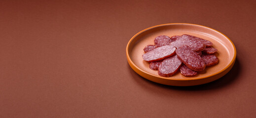 Sliced salami sausage, smoked meat as a delicacy for the table. Salami sausage