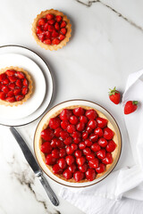 Strawberry Tarts with Rustic Tableware on White Background