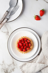 Strawberry Tart with White Tableware on White Background