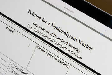 Form I-129, Petition for a Nonimmigrant Worker, is seen from the website of U.S. Citizenship and Immigration Services (USCIS) on the screen of a computer.