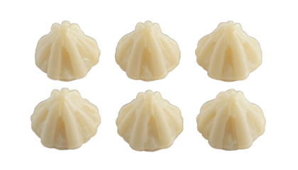 Six White Chocolate Modak Candies on Black Background isolated on a transparent background