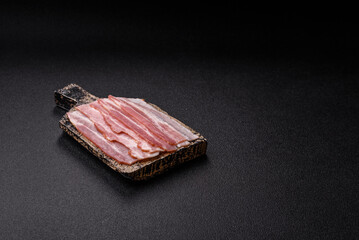Raw or smoked pork bacon slices or strips as a breakfast ingredient. Raw bacon