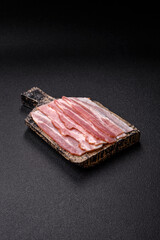 Raw or smoked pork bacon slices or strips as a breakfast ingredient. Raw bacon