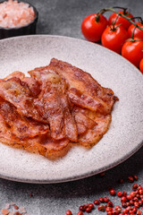 Fried pork bacon slices or strips as a breakfast ingredient. Fried bacon