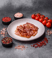 Fried pork bacon slices or strips as a breakfast ingredient. Fried bacon
