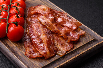 Fried pork bacon slices or strips as a breakfast ingredient. Fried bacon