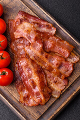 Fried pork bacon slices or strips as a breakfast ingredient. Fried bacon