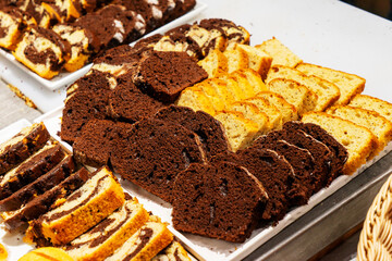 A showcase with amazingly beautiful and sweet cakes made of flour, cream, chocolate and different berries. Coffee shop and pastries.
