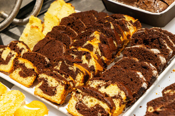 A showcase with amazingly beautiful and sweet cakes made of flour, cream, chocolate and different berries. Coffee shop and pastries.