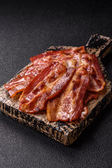 Fried pork bacon slices or strips as a breakfast ingredient. Fried bacon