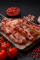 Fried pork bacon slices or strips as a breakfast ingredient. Fried bacon