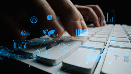 A close-up image showcasing hands typing on a computer keyboard, overlaid with digital graphs and data visualizations, illustrating technology and analytics in a modern workspace. Xenic