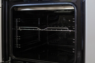 Obraz premium An open oven with metal grates, ready for cooking