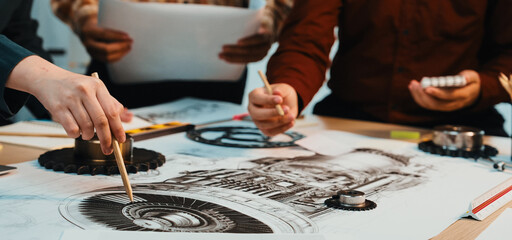 A dynamic scene showcasing a collaborative design process, with hands gesturing over sketches on a table, highlighting teamwork and innovation in a modern workspace. SACTR