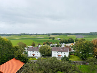 Serene German Andechs countryside village with white houses and rolling green fields in a tranquil setting