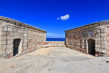 Obraz premium Fortificación costera simétrica con vista al mar y cielo despejado