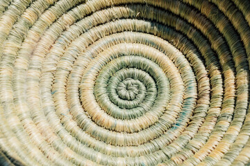 close up of handwoven spiral basket in light green