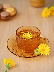 still life with calendula tea in a beautiful yellow glass cup