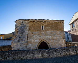 The ancient stone facade of the medieval Hermitage of Nuestra Se&ntilde;ora del Socorro in Poblaci&oacute;n de Campos, Spain