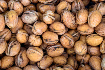 Fresh unshelled walnuts at the market.