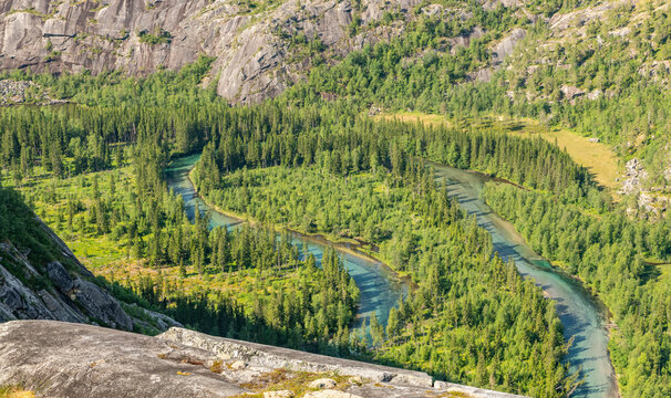 Storskogelva river in Storskogdalen valley surrounded with amazing mountains. Remote pristine wilderness in Norway, Rago national park. View from mountain. Summer day, beautiful hiking area.