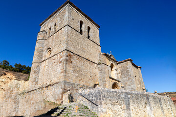 Fototapeta premium The imposing fortress-like Romanesque tower of the Church of Saint Mary in Villarén de Valdivia, Palencia, Spain