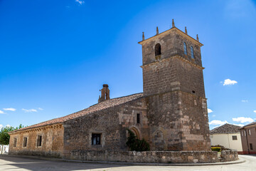 Obraz premium The Church of Nuestra Señora de la Asunción with its bell tower and a stork's nest in the village of Villabermudo, Palencia, Spain