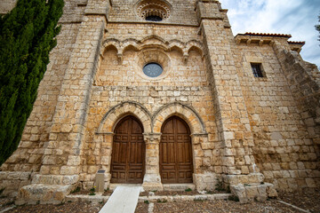 The historic Romanesque-Gothic western facade and main portal of the Santa Maria la Mayor church in Villamuriel de Cerrato, Spain
