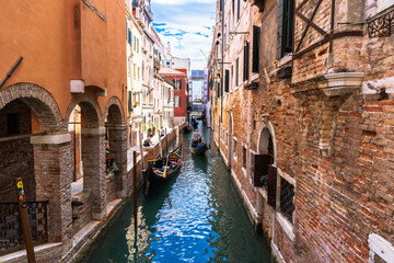 Venetian Canal Scene: Gondolas glide through the waterways, framed by historic buildings in this charming European city.