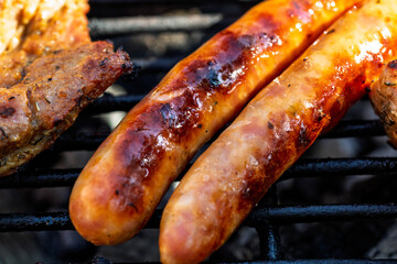 Pork chops, steak, sausages on barbecue grill