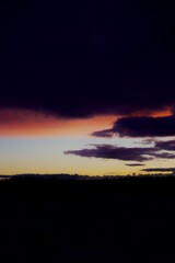 Sunset over the forest in the clouds