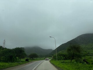 Beautiful road in Salalah, Oman, captured in natural daylight. The image/footage showcases smooth and well-maintained roads surrounded by greenery, mountains, or open landscapes unique to southern Oma