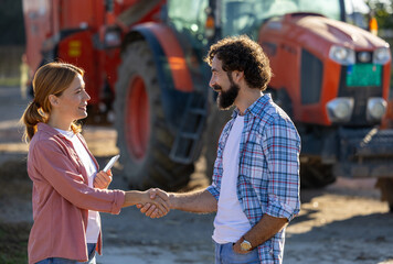 People shaking hands at a farm