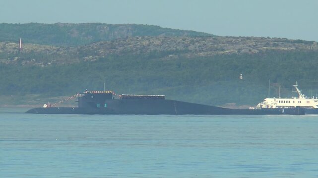 SEVEROMORSK, RUSSIA - July 29, 2013. Day of the Navy of Russia. Nuclear submarine Verkhoturye in a festive flags colorization in the Kola Bay.