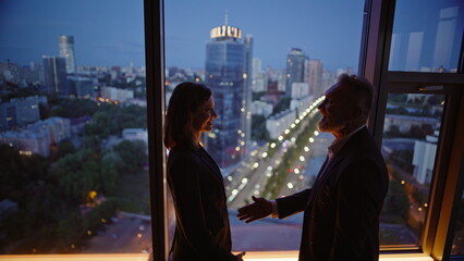 Business team shaking hands making deal at evening office closeup. Two partners