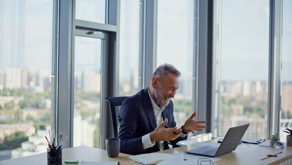 Laughing businessman have videocall sitting contemporary workplace closeup. 