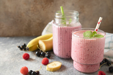 Refreshing mixed berry and banana smoothie with mint garnish.