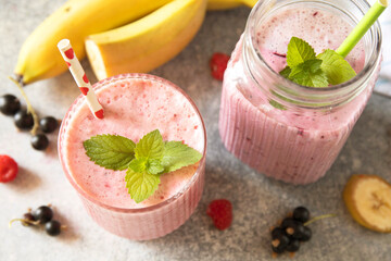 Refreshing mixed berry and banana smoothie with mint garnish.