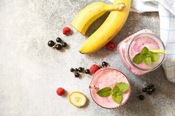 Refreshing mixed berry and banana smoothie with mint garnish.