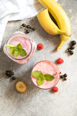 Refreshing mixed berry and banana smoothie with mint garnish.